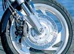 The cast wheels are a standout feature on the VTX. Brakes are linked, with about 30 percent of front disc power tied to 100 percent of the rear brake through the foot pedal. This works well and doesn't feel strange.